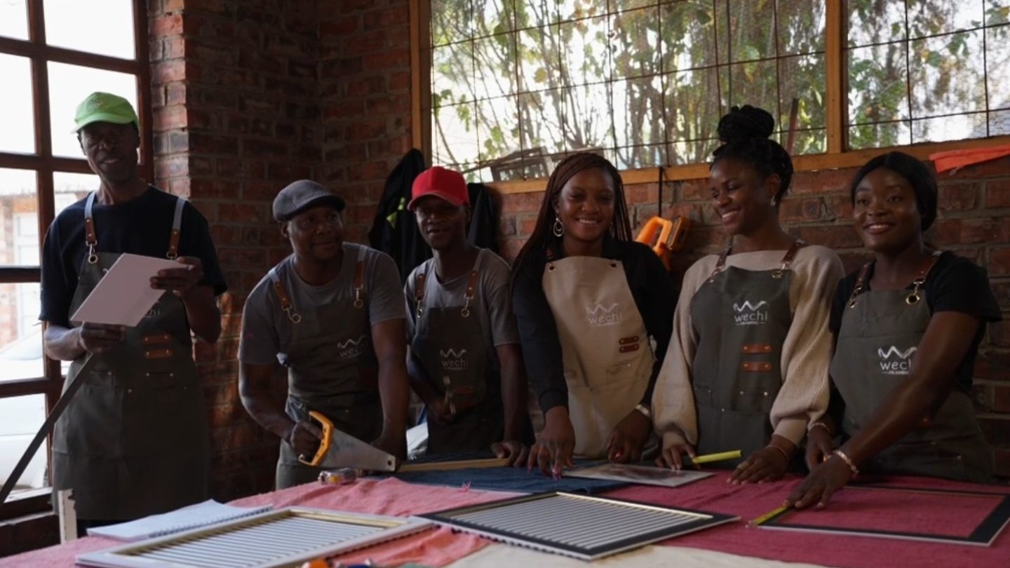 The Wechi workshop team in aprons at the cutting table